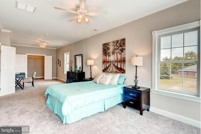 carpeted bedroom featuring ceiling fan and crown molding