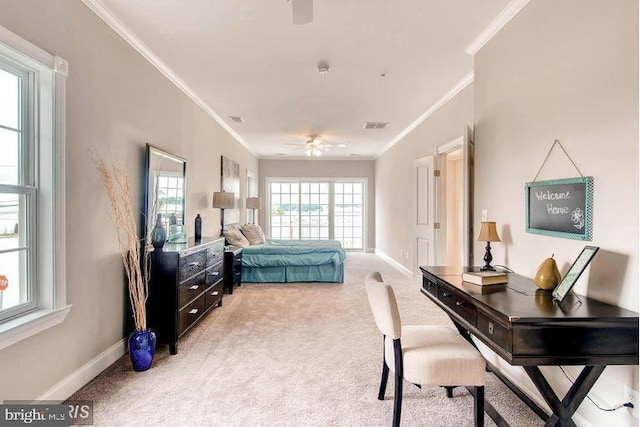 carpeted bedroom with ceiling fan and ornamental molding