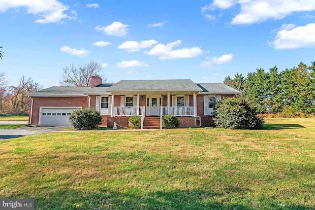 single story home featuring a front yard, a porch, and a garage