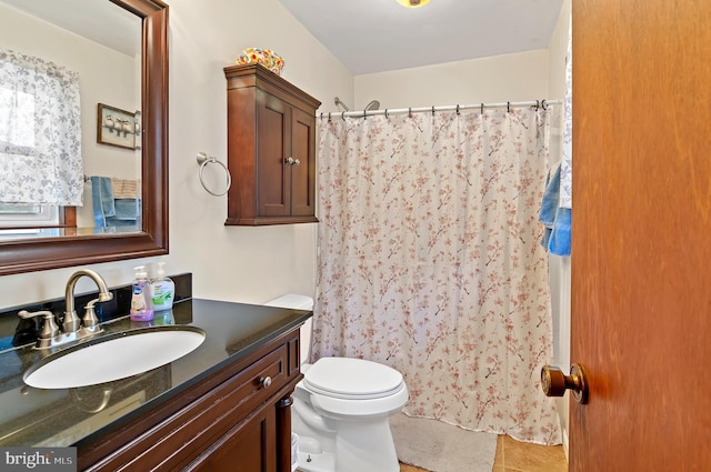 bathroom featuring tile patterned flooring, vanity, toilet, and a shower with shower curtain