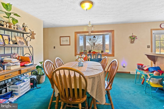 dining space featuring carpet flooring and a textured ceiling