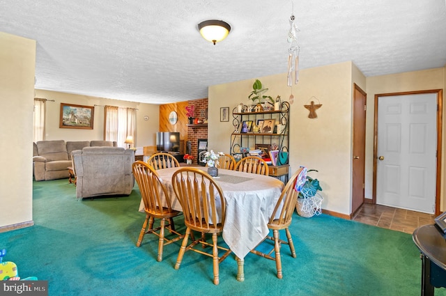 dining space featuring carpet flooring, a textured ceiling, and a brick fireplace