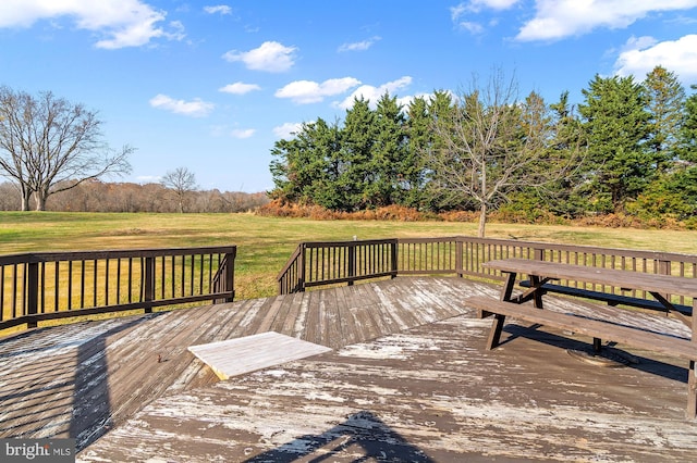 wooden deck featuring a yard