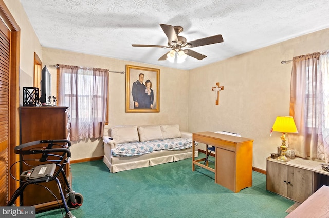 interior space featuring carpet flooring, ceiling fan, and a textured ceiling