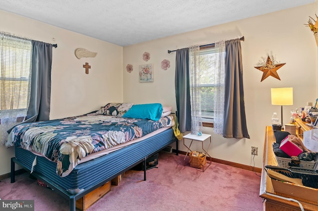 carpeted bedroom featuring a textured ceiling