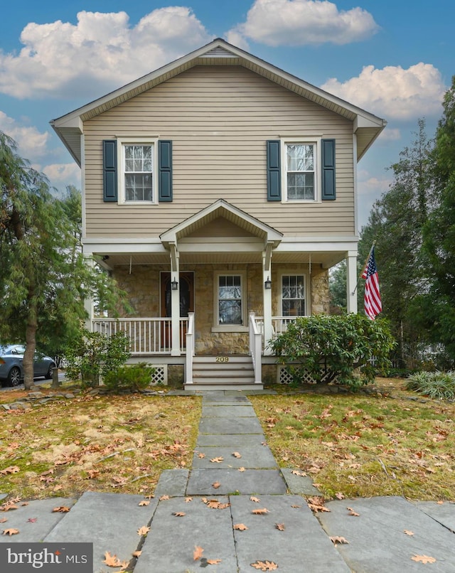 view of front of property with a porch and a front lawn