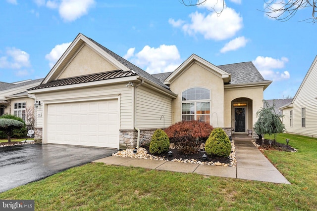 view of front of property with a garage and a front yard