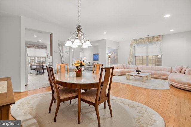 dining space featuring a chandelier and light wood-type flooring