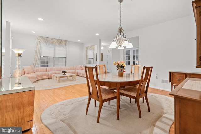 dining room featuring a chandelier and light hardwood / wood-style flooring