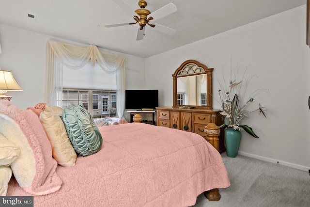 bedroom featuring ceiling fan and light carpet