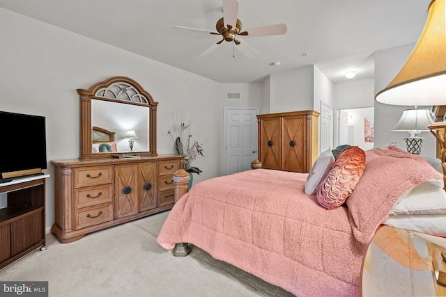 bedroom with ceiling fan and light carpet