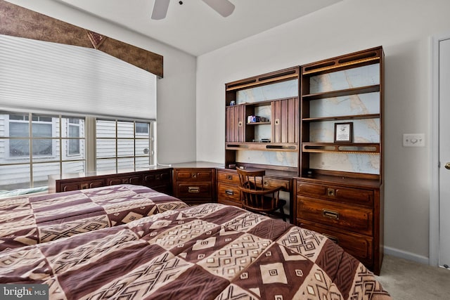 bedroom with ceiling fan, lofted ceiling, and carpet floors