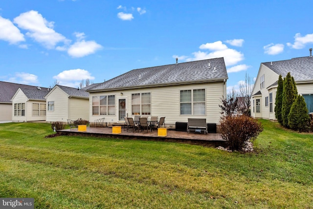 rear view of property featuring a lawn and a patio area