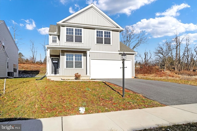 front facade featuring a garage and a front lawn