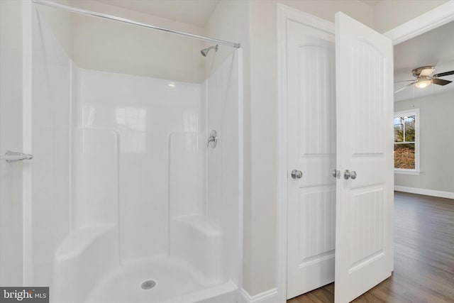 bathroom featuring hardwood / wood-style floors, ceiling fan, and walk in shower