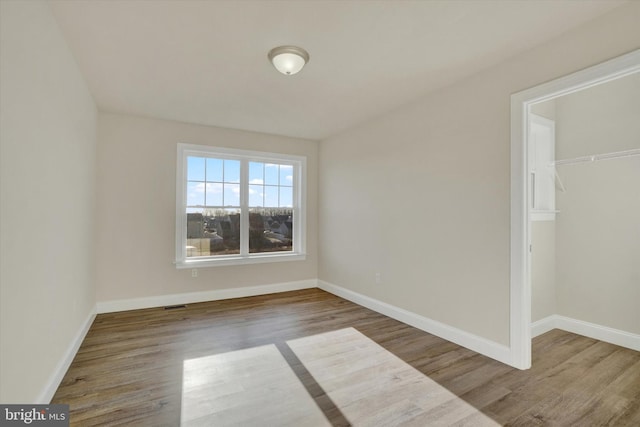 empty room featuring wood-type flooring