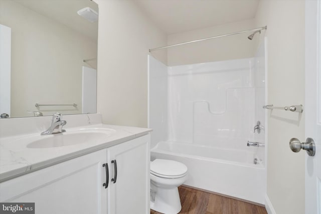 full bathroom featuring shower / bathing tub combination, toilet, vanity, and hardwood / wood-style flooring