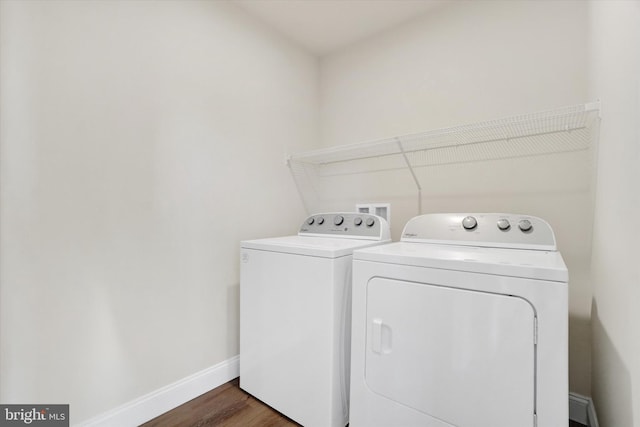 laundry room featuring separate washer and dryer and dark wood-type flooring