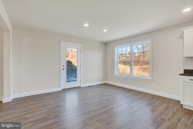 unfurnished dining area with light hardwood / wood-style flooring