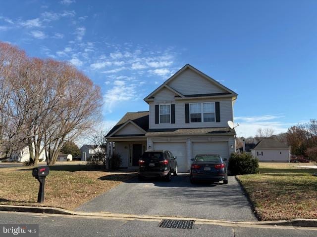 view of property featuring a front lawn and a garage