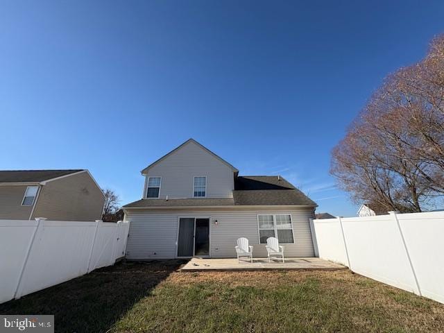 back of property featuring a lawn and a patio area