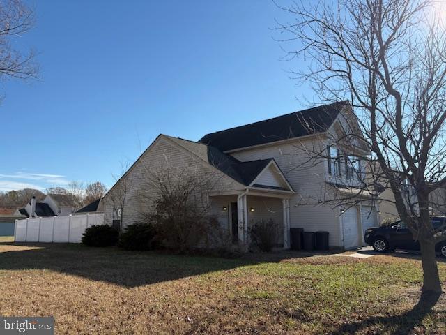 view of front of home featuring a garage and a front lawn