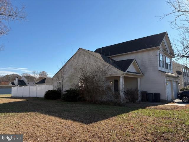 view of side of property with a garage and a yard