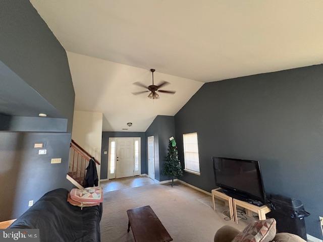 living room with carpet flooring, ceiling fan, and lofted ceiling