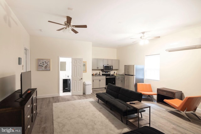 living room with light wood-type flooring and ceiling fan