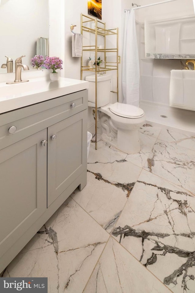 bathroom featuring toilet, vanity, and a shower with shower curtain