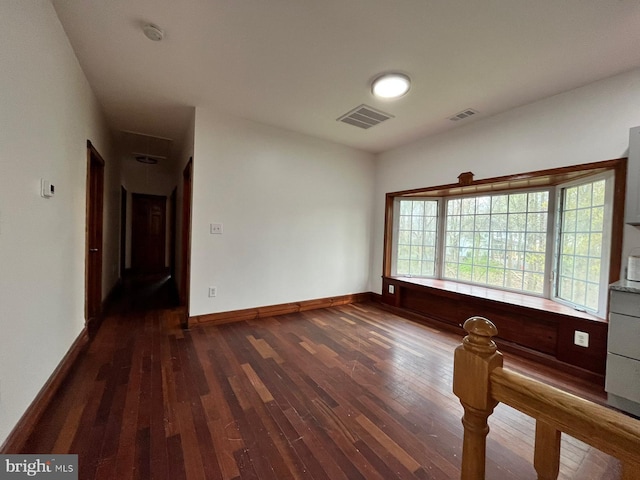 unfurnished room with dark hardwood / wood-style flooring