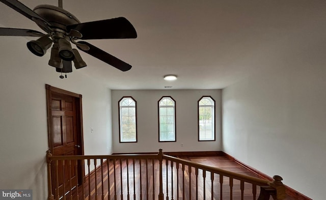 empty room with hardwood / wood-style floors and ceiling fan