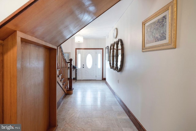 doorway to outside featuring vaulted ceiling