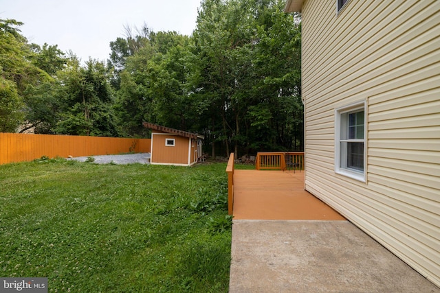 view of yard with a storage shed and a deck