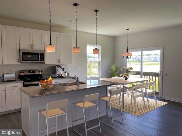 kitchen with white cabinets, plenty of natural light, sink, and stainless steel appliances