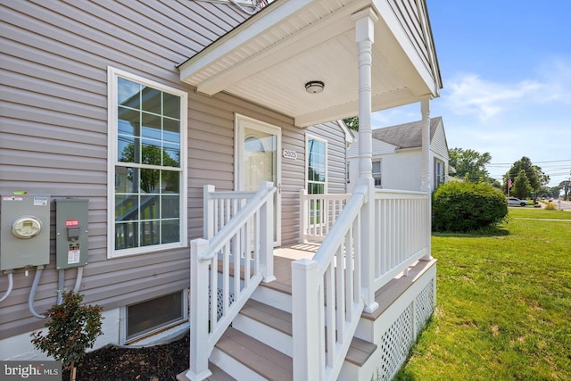 view of exterior entry featuring a yard