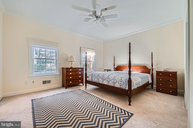 carpeted bedroom featuring ceiling fan and crown molding