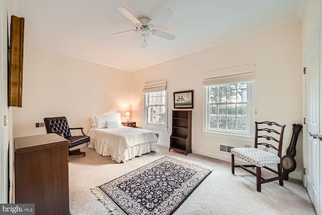 carpeted bedroom featuring ceiling fan and ornamental molding