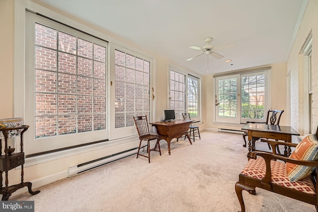 sunroom / solarium with ceiling fan and a baseboard heating unit