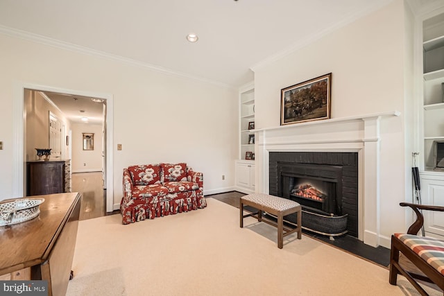 living room with wood-type flooring, a brick fireplace, built in shelves, and ornamental molding