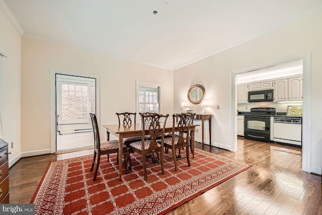 dining room with dark hardwood / wood-style flooring, crown molding, and plenty of natural light