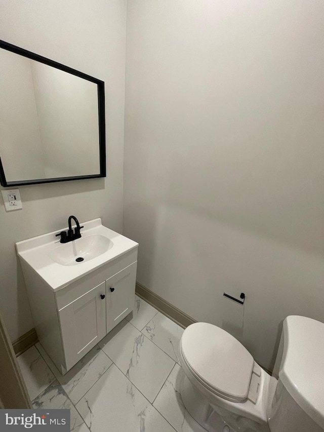 bathroom featuring vanity and toilet