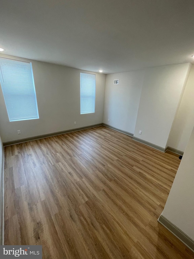 unfurnished room featuring hardwood / wood-style flooring