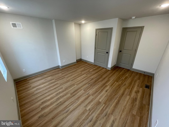 spare room with light hardwood / wood-style flooring