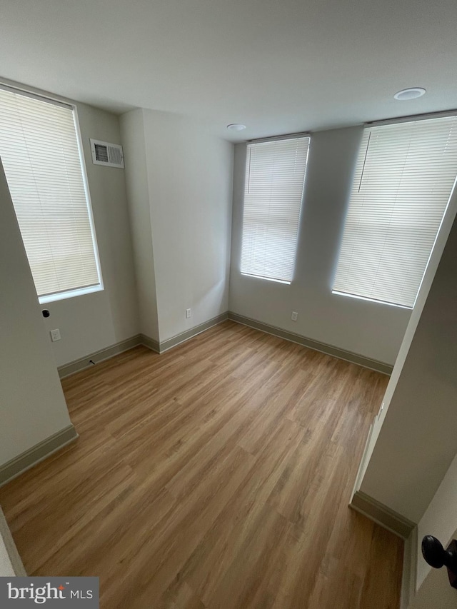 empty room with light hardwood / wood-style floors