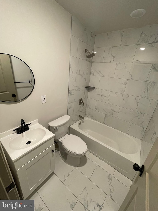 full bathroom with toilet, vanity, and tiled shower / bath