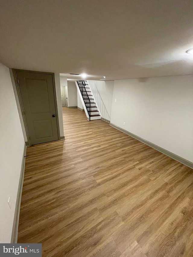 basement with light hardwood / wood-style floors