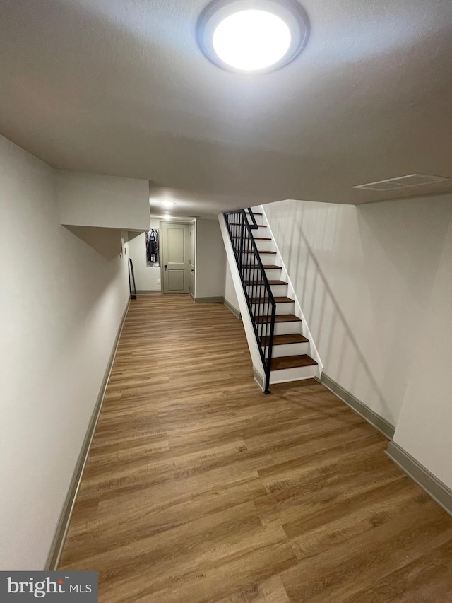 basement with hardwood / wood-style floors