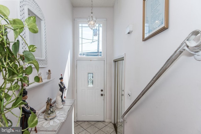 tiled entryway with an inviting chandelier