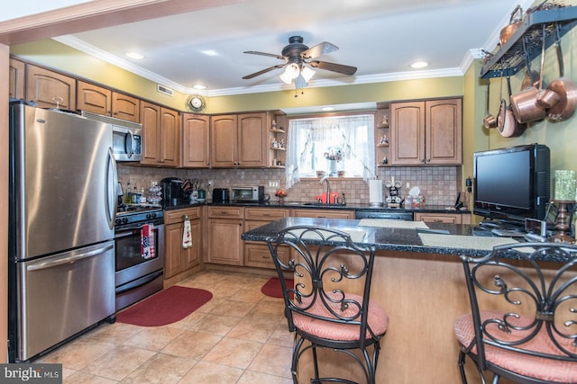 kitchen featuring decorative backsplash, a breakfast bar, ornamental molding, and appliances with stainless steel finishes